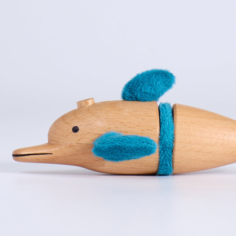 Wooden toy dolphin with blue accents on a white background