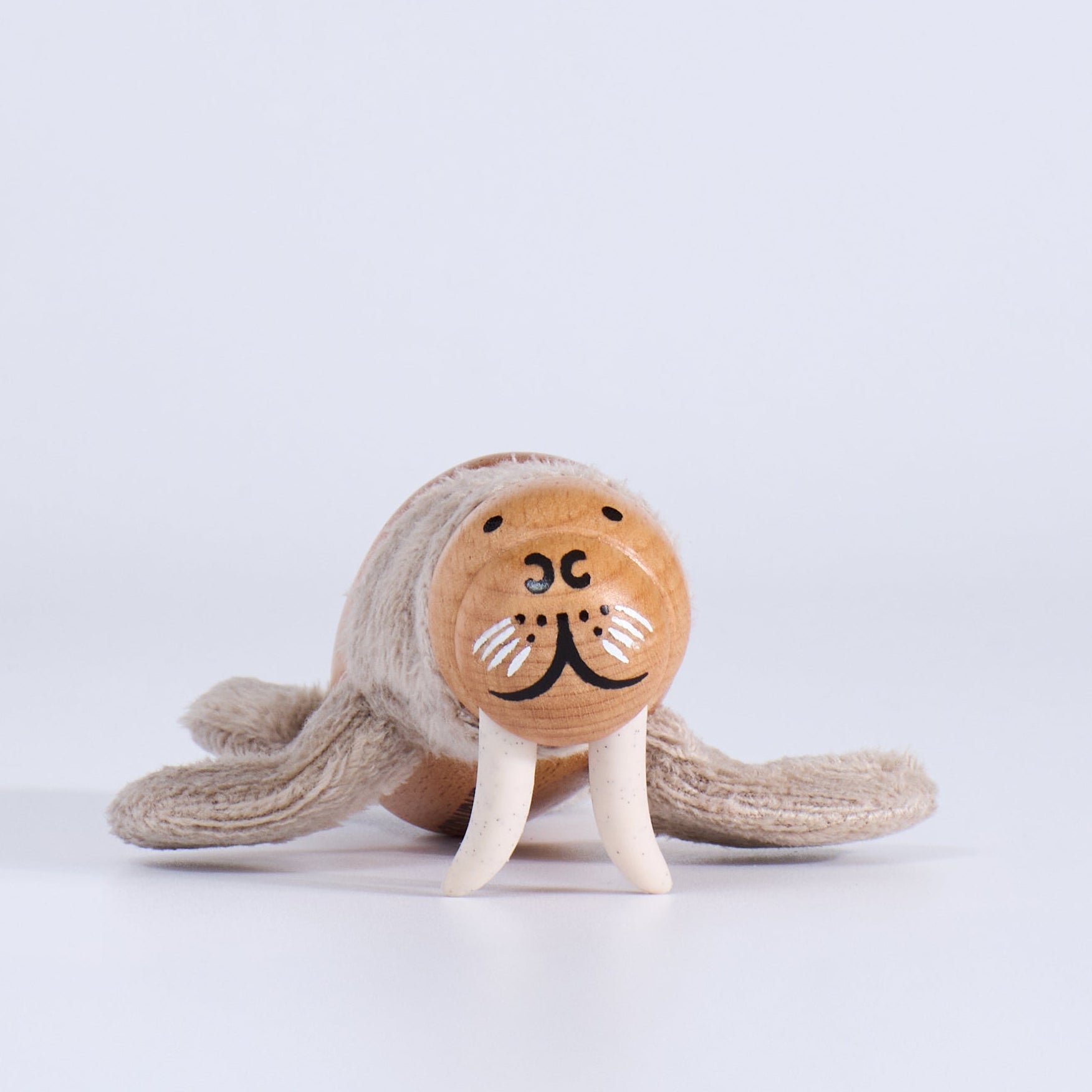 Wooden toy walrus on a white background